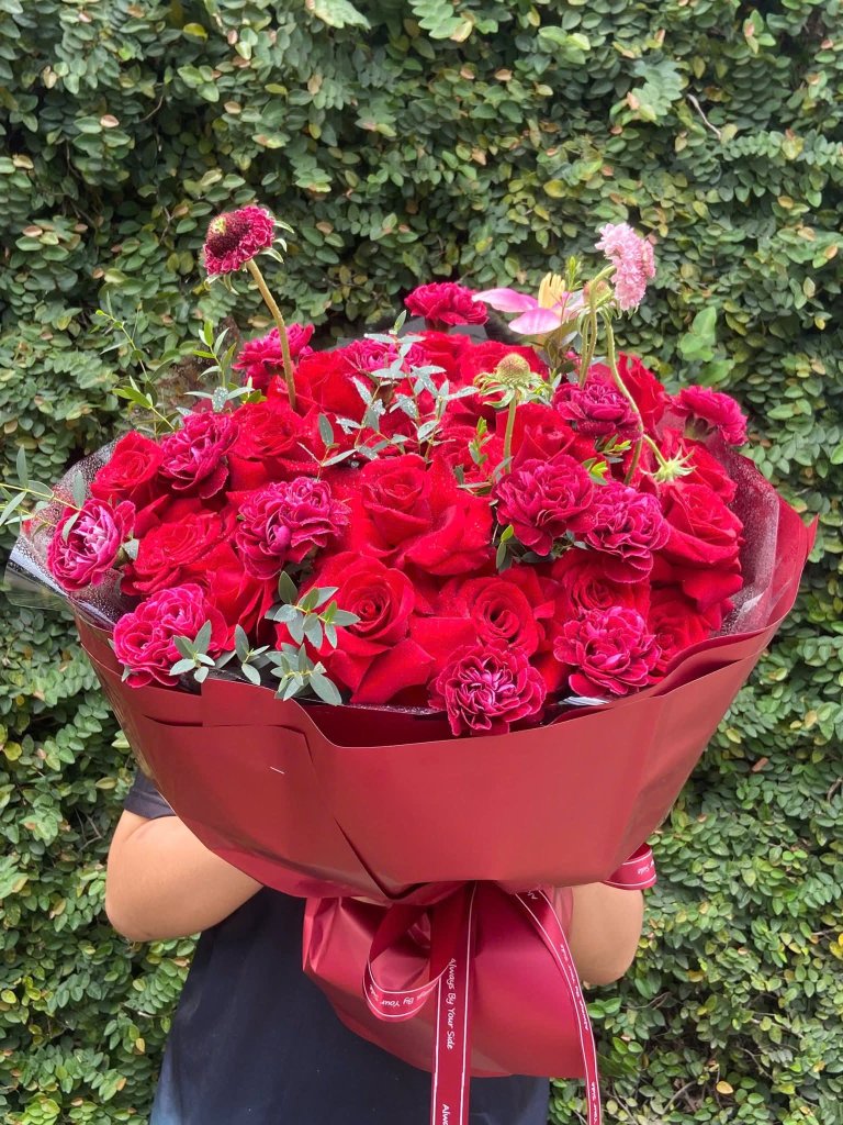 Bó hoa hồng đỏ sang trọng tại STflowers Quận 7 dùng làm quà tặng tình yêu.